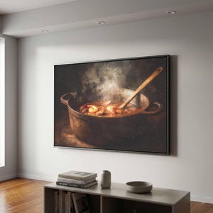 May include: A rectangular wall art print featuring a dark, moody painting of a rustic metal pot filled with a steaming shrimp and sausage stew. A wooden spoon rests inside the pot, which is set against a deep, shadowed background.