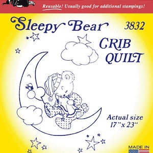 May include: A yellow Aunt Martha's iron-on transfer package for a Sleepy Bear crib quilt, model 3832. The packaging features a line drawing of a bear on a crescent moon with stars and clouds, and states an actual size of 17 inches by 23 inches.
