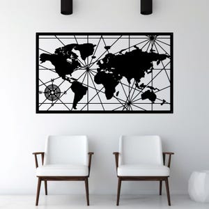 May include: A black metal world map wall art piece with a compass rose design. The map is a silhouette of the continents with connecting lines. The artwork is mounted on a white wall above two white chairs.