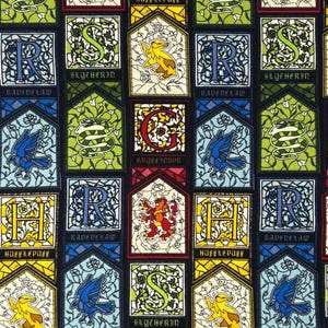 May include: A fabric pattern featuring a repeating stained glass design with crests and symbols representing four houses. The print includes letters H, S, R, and G, along with animals like a lion, snake, badger, and raven, set against a black background.