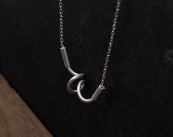 Twist pendant necklace in brushed silver