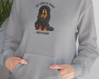 May include: A grey hoodie with a front pocket and a drawstring hood. The hoodie displays a graphic of a Tibetan Mastiff dog with the text "MY GENTLE GIANT" above the dog and "BODYGUARD" below.