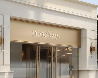 May include: Exterior view of a building with a gold-colored facade and glass doors. The word "mockup" is displayed in a white, elegant font above the entrance. Decorative wall sconces and a small vase of flowers are visible.