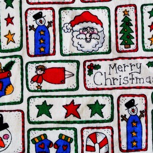 May include: A white fabric with a repeating pattern of Christmas-themed illustrations. The illustrations include a snowman, Santa Claus, a stocking, a Christmas tree, a candy cane, mittens, and the words "Merry Christmas".