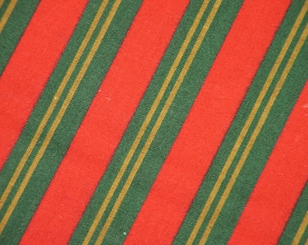 Vintage 1980s christmascolor fabric in highquality unused cotton/ synthetic with green/ mustard printed striped pattern on red bottomcolor