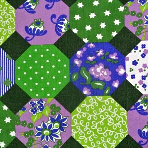 May include: A patchwork quilt with a hexagonal pattern. The quilt is made of different fabrics with various colours and patterns, including green, purple, blue, and white.