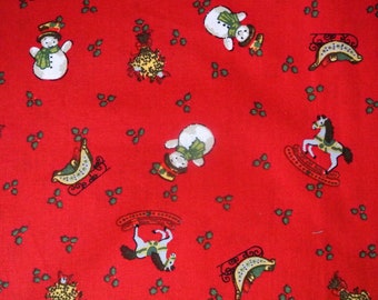 Vintage 1980s christmas fabric in highquality unused cotton with rather small printed snowman/ rocking-horse/ sleidh pattern on red bottom