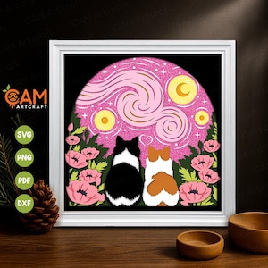 May include: A framed art piece featuring two cats gazing at a starry night scene. The artwork includes a pink glitter background, yellow stars and moon, and pink flowers. The frame is white, and the overall design is whimsical.