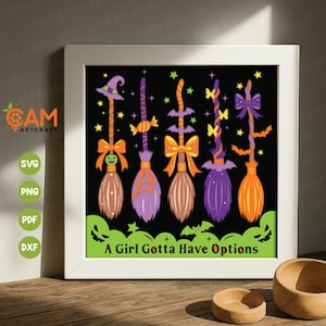 May include: A framed Halloween-themed digital art print featuring five colorful witch brooms with bows and stars against a black background. The text "A Girl Gotta Have Options" is displayed at the bottom. The image is in a white frame.