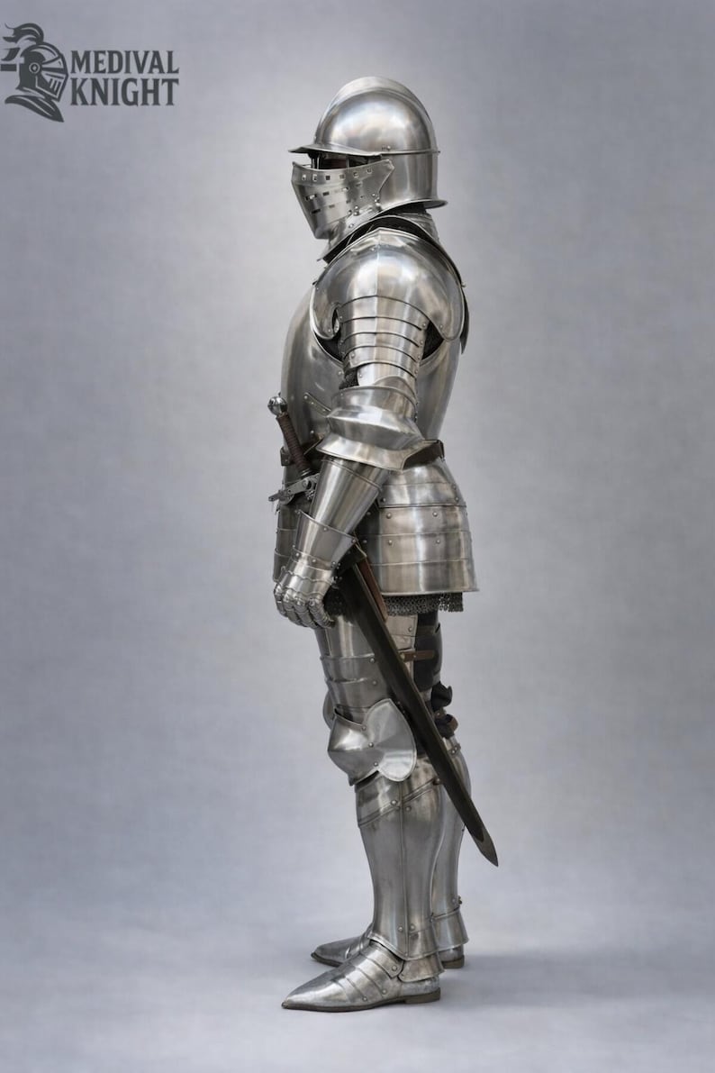 May include: A full suit of polished steel armor, including a helmet with a visor, chest and back plates, arm and leg protection, and gauntlets. A sword is held at the side. The logo "MEDIVAL KNIGHT" is in the upper left corner.