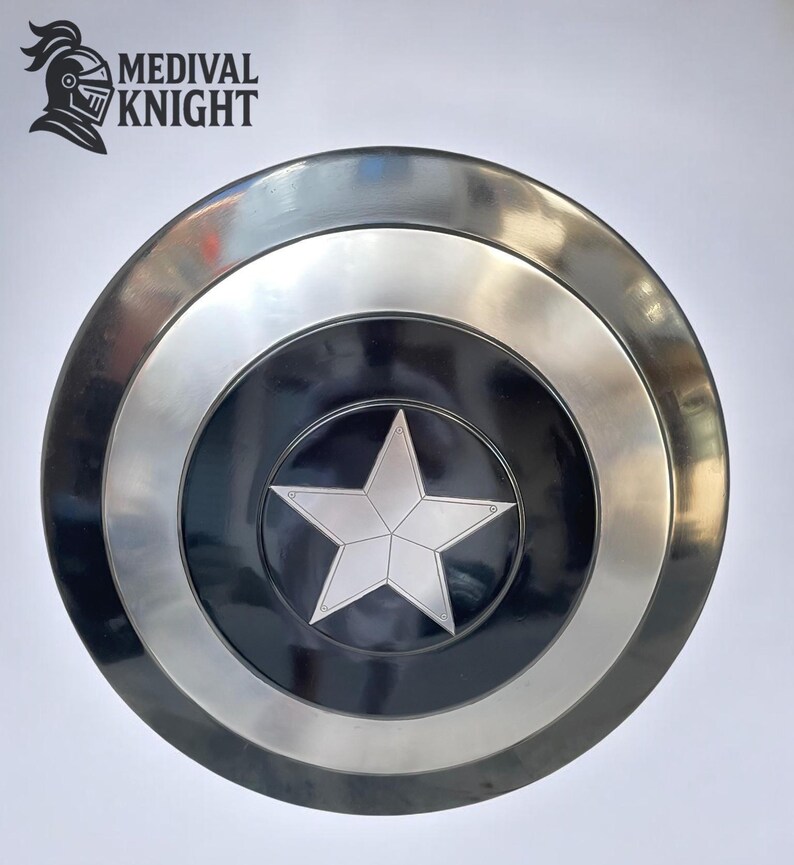 May include: A round, metallic shield with a silver star in the center, set against a black background. The shield has a silver border and a dark outer ring. The logo "MEDIVAL KNIGHT" is in the upper left corner.
