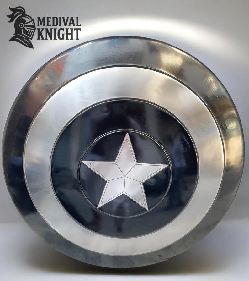 May include: A round, metallic shield with a central black circle featuring a silver five-pointed star. The shield has concentric silver and black rings, with the text "MEDIVAL KNIGHT" and a knight's helmet logo in the upper left corner.