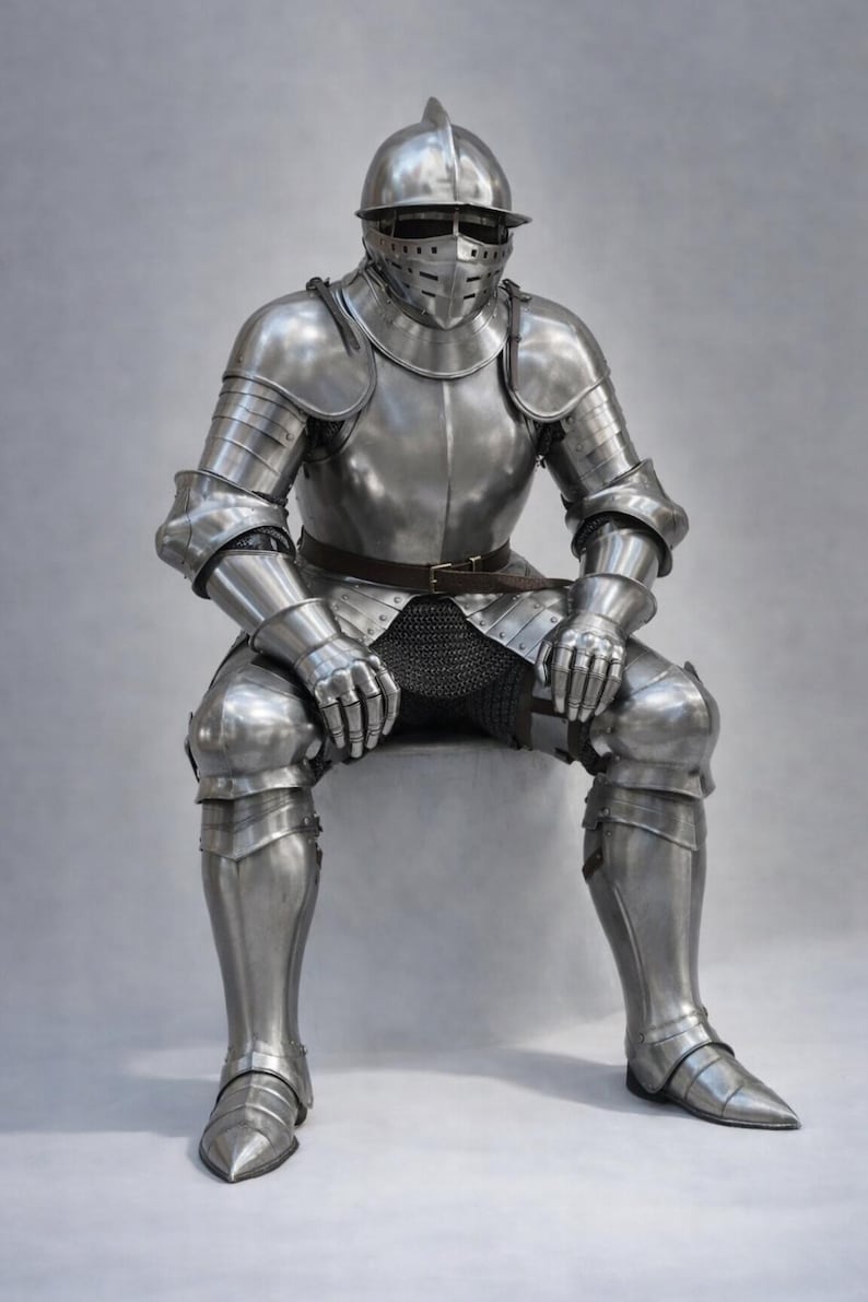 May include: Full suit of polished steel armor, including a helmet with a visor, shoulder and arm protection, and leg and foot coverings. The armor is complete with a chainmail shirt and a brown belt. The knight is seated.