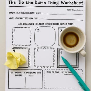 May include: A notepad with a spiral binding, titled "The 'Do the Damn Thing' Worksheet." The worksheet is designed for planning and problem-solving. A coffee cup, a teal pen, and crumpled yellow paper are also present.