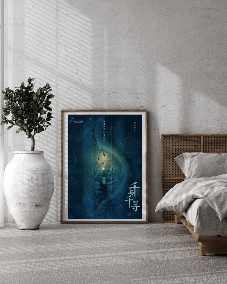 May include: A framed poster with a blue and teal abstract design, featuring Chinese characters. The poster is displayed on a light gray wall, next to a large white vase with a green plant. A bed with a wooden headboard is visible.