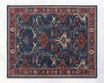 May include: A rectangular area rug featuring a deep blue background with intricate geometric and floral patterns in shades of rust red, cream, and light blue. The rug has a wide, detailed border with repeating motifs and a dark blue edge.