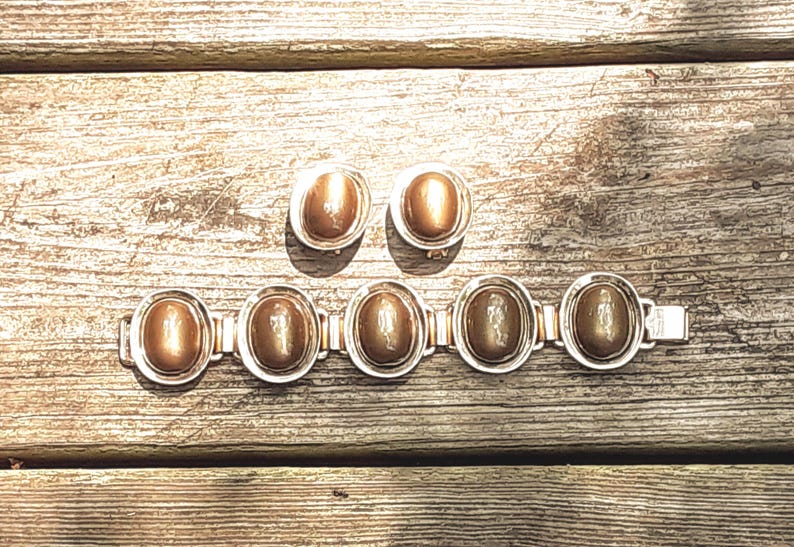Signed Berger'e Vintage Jewelry Set: Moonglow Stone Bracelet and Clip Earrings from  Yours, Occasionally. Marvelous bracelet and clip earrings make up this set featuring a minimalist design of oval links. The bracelet is 7 7/8" long and 1 1/8" wide while the earrings are 1 3/8" long and  1 1/8" wide. The set shows a bit of wear, but I still rate it as being in excellent vintage* condition.