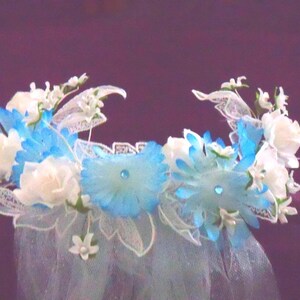 Handmade Veil Flowered Headpiece Aqua Tulle Mermaid Wedding Bridal Bride Beach Garden Halloween Costume Cosplay from Yours, Occasionally. Sparkly aqua tulle wedding veil was created to be a simple column down a bride's back at her beautiful beach wedding - it is just a wisp of color. Or use it for a Mermaid's wedding Halloween costume. The attached headpiece is designed to sit nicely on your head. It would also look amazing at a garden wedding! The veil is 6' long. Can be shortened on request.