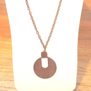 Reclaimed Vintage Earring into Pendant with Chain Necklace Copper Color: Artisan-made from Yours, Occasionally. I used a vintage earring to make the pendant and found a new chain to match. The pendant is 2 5/8" tall and 2" wide. The chain is 27 3/4" long and 3 1l6" wide. Artisan-made by 
shop owner in January, 2026.