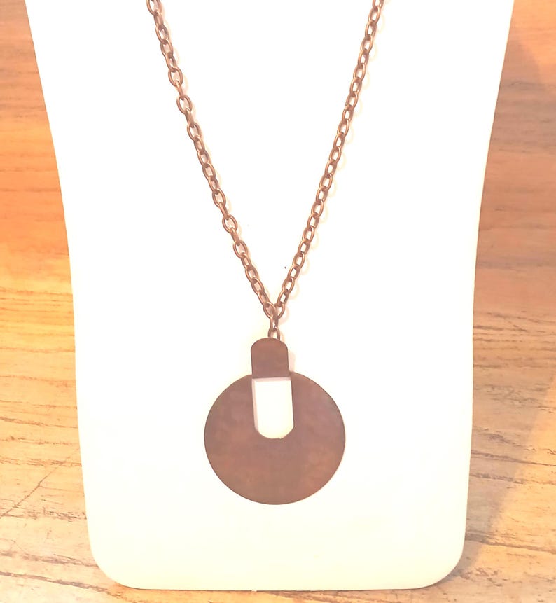 Reclaimed Vintage Earring into Pendant with Chain Necklace Copper Color: Artisan-made from Yours, Occasionally. I used a vintage earring to make the pendant and found a new chain to match. The pendant is 2 5/8" tall and 2" wide. The chain is 27 3/4" long and 3 1l6" wide. Artisan-made by 
shop owner in January, 2026.