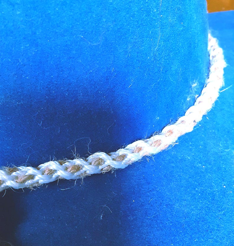 Handmade Kumihimo Braided Hatband: Beige & White Twine Cotton Hat Jewelry from Yours, Occasionally. Kumihimo, braided hatband was made from two different strings. One is twine, one is cotton. The hatband is 25" long and 5/16" wide so it can be tied around your hat. The hatband was made by an artisan in my company.
