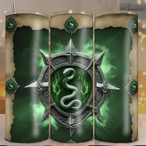 May include: A green and silver tumbler featuring a shield design with a snake and the letter "S". The design is set against a green background with a parchment-like border. The tumbler has a silver straw.