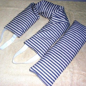 May include: A set of three striped fabric items, possibly for therapeutic use. The items are white with navy blue stripes. Two have white fabric loops attached.