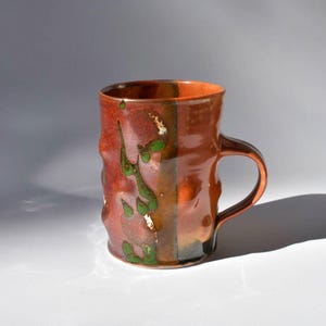 May include: A set of three ceramic nesting bowls in shades of blue, green, and white. The bowls feature a speckled glaze and a simple, modern design. The largest bowl measures approximately 6 inches in diameter.