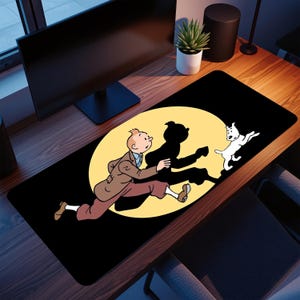 May include: Black rectangular desk mat featuring a cartoon illustration of a running figure with a dog and a shadow. The figure is wearing a brown suit and the dog is white. The background is a yellow circle.