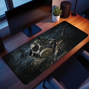 Peut inclure: Tapis de bureau rectangulaire avec une image vieillie d'un masque à gaz et d'un soldat tenant un fusil. La palette de couleurs est sombre, avec des nuances de gris, de marron et de vert. Une grande roue est visible en arrière-plan.