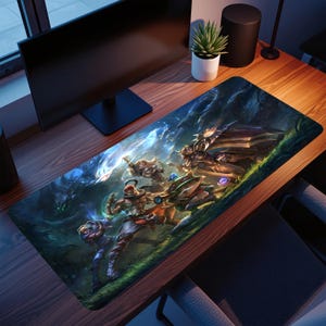 May include: A rectangular desk mat featuring a vibrant fantasy illustration of four armoured warriors in a dark, magical forest setting. The artwork displays characters with glowing weapons and shields amidst swirling blue energy and green foliage.