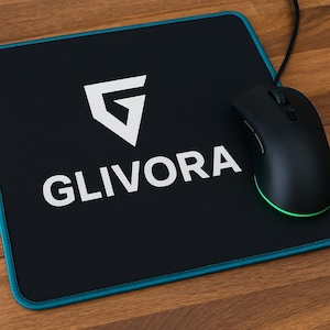 May include: Black computer mouse and mousepad. The mousepad is black with a teal border and the word "GLIVORA" in white, along with a white logo. The mouse is black with a green light.