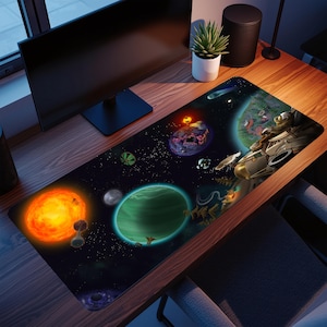 May include: A rectangular desk mouse mat with a colourful space scene, including planets, stars, and a spaceship. The design features a bright orange sun, a green planet, and various celestial bodies against a dark backdrop. The mat is on a wooden desk.