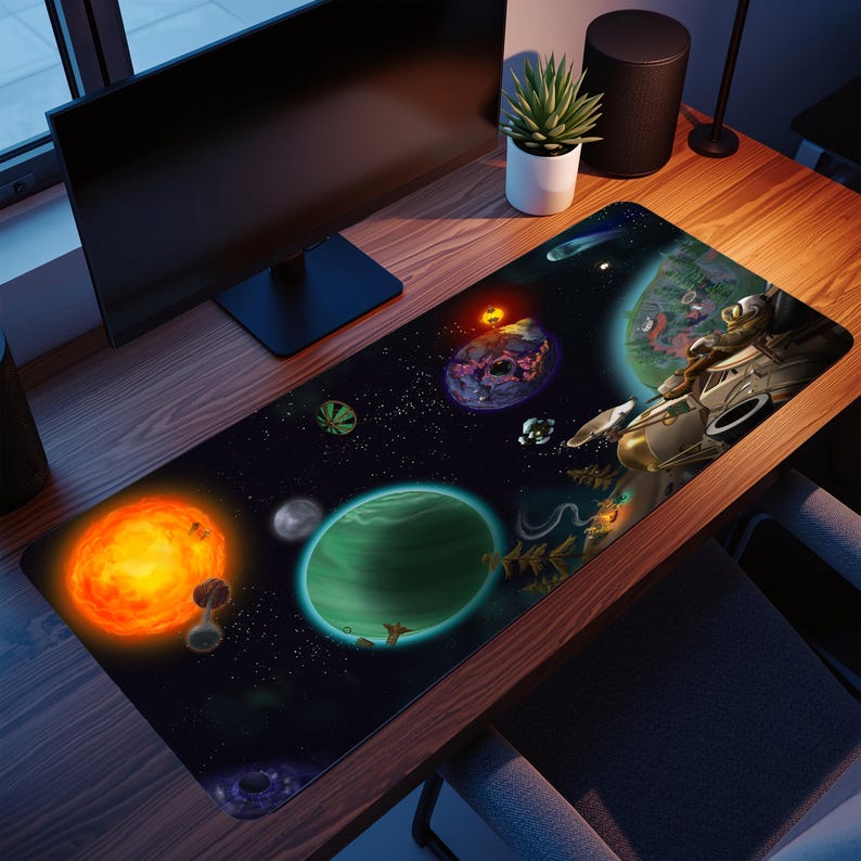 May include: A rectangular desk mouse mat with a colourful space scene, including planets, stars, and a spaceship. The design features a bright orange sun, a green planet, and various celestial bodies against a dark backdrop. The mat is on a wooden desk.