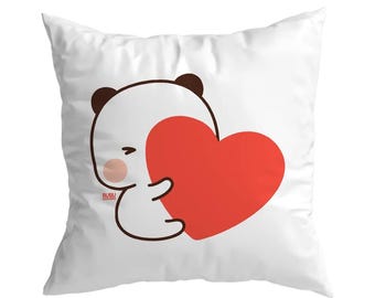 May include: White square pillow featuring a cartoon panda character hugging a large red heart. The panda has brown ears and a blush on its cheek. The pillow has the text "BUBU & DODO" in the bottom left corner.