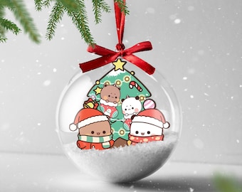 May include: A clear Christmas ornament with a red ribbon and bow, hanging from a pine branch. Inside, cartoon bears and pandas in Santa hats and scarves surround a Christmas tree, resting on a bed of white snow.
