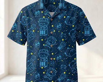 May include: Navy blue button-down shirt with a repeating pattern of cartoon bears with suitcases, space helmets, and stars. The short-sleeved shirt has a classic collar and wooden buttons. The design is in shades of blue and yellow.