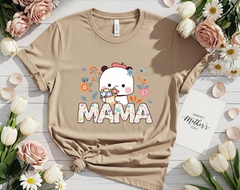 May include: A tan t-shirt featuring a cartoon panda holding flowers, with the word "MAMA" in colorful letters. The shirt has a crew neck and short sleeves. A card with "Happy Mother's Day" is visible.