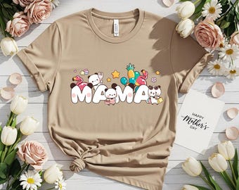 May include: Tan t-shirt with the word "MAMA" in white bubble letters, decorated with cartoon characters and tropical elements. A card with "Happy Mother's Day" is visible. Floral arrangement of roses and daisies.