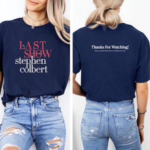 May include: Navy blue t-shirt with the text "the LAST SHOW with stephen colbert" in red and white on the front. The back of the shirt says "Thanks For Watching!" in white.