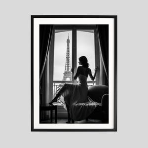 May include: Monochrome framed print featuring a woman in a dress gazing out of a window at the Eiffel Tower in Paris. The woman is seated on a sofa. The image is a silhouette.