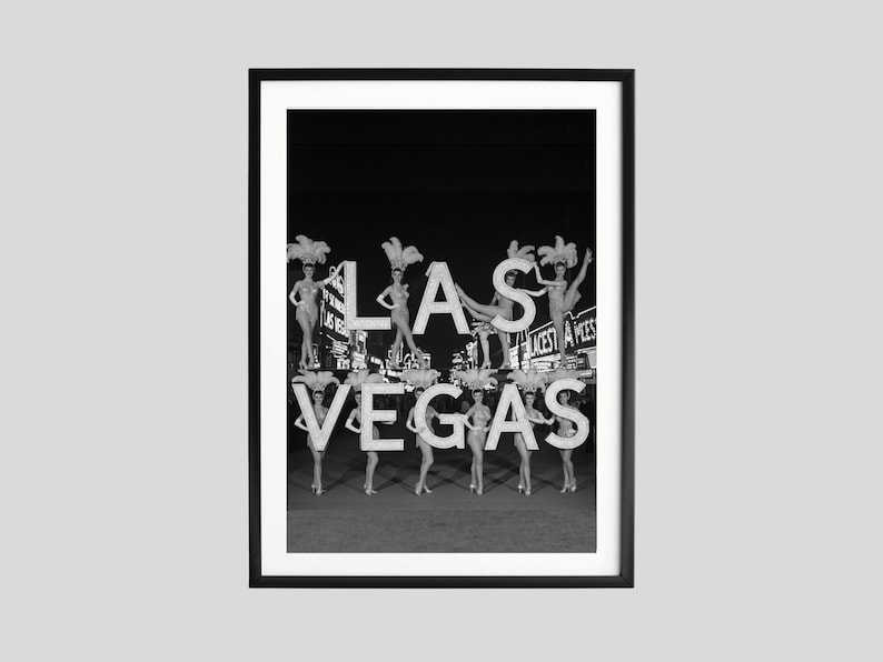 May include: Black and white framed print featuring the word "LAS VEGAS" with showgirls posing on and around the letters. The image captures a vintage aesthetic, evoking the glamour of Las Vegas.