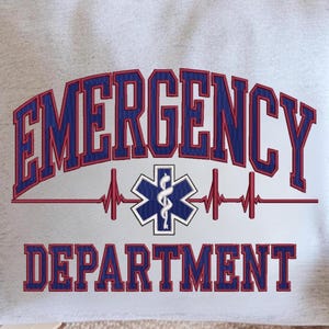 May include: A light gray textile with the words "EMERGENCY DEPARTMENT" in blue and red lettering. A medical symbol is centered between the words, with a red heartbeat line. The design is embroidered.