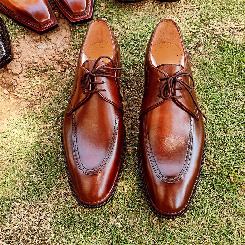 Brown derby shoes for men with smooth leather finish and open lacing design suitable for US, UK, Canada, Australia, Switzerland, and Pakistan markets.
