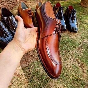 Brown derby shoes for men with smooth leather finish and open lacing design suitable for US, UK, Canada, Australia, Switzerland, and Pakistan markets.
