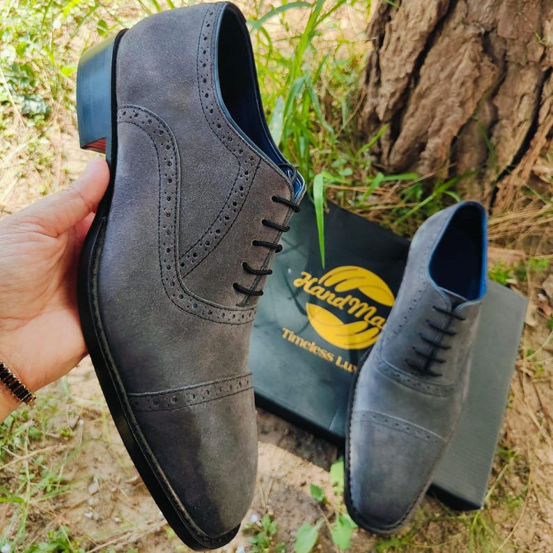 Handmade grey suede oxfords with leather sole and cushioned insole, crafted for men’s formal and business wear.