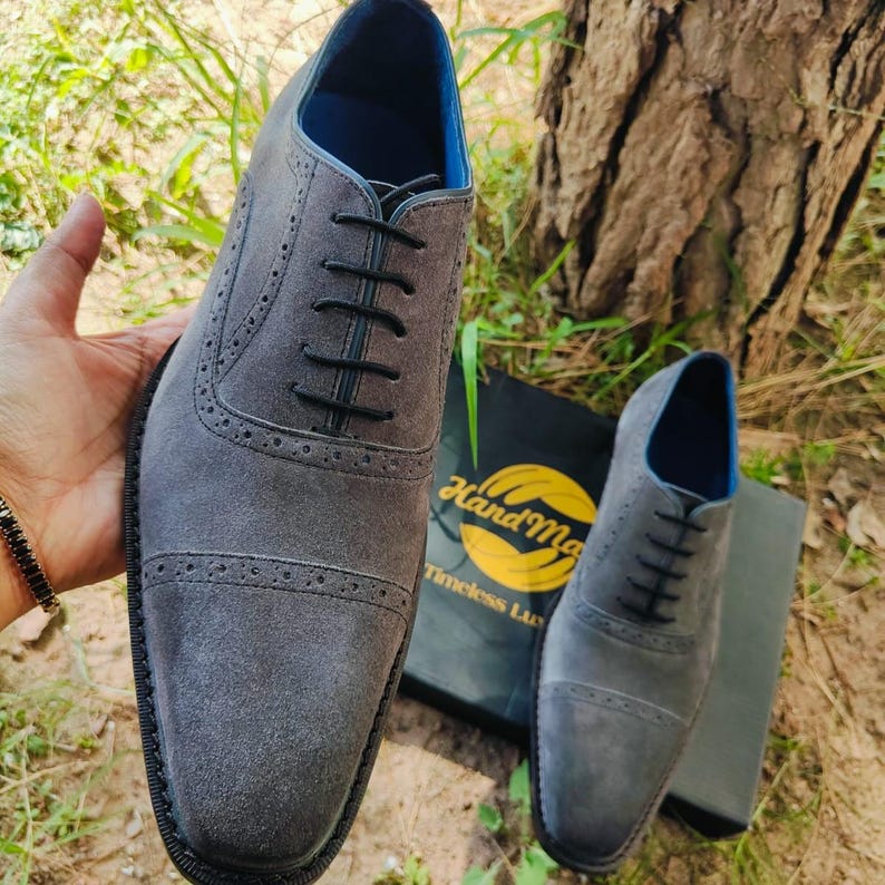 Handmade grey suede oxfords with leather sole and cushioned insole, crafted for men’s formal and business wear.