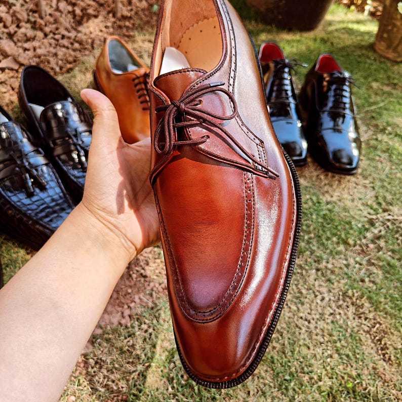 Brown derby shoes for men with smooth leather finish and open lacing design suitable for US, UK, Canada, Australia, Switzerland, and Pakistan markets.
