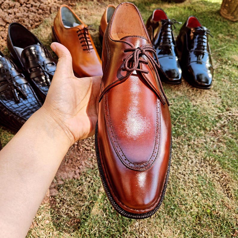 Brown derby shoes for men with smooth leather finish and open lacing design suitable for US, UK, Canada, Australia, Switzerland, and Pakistan markets.