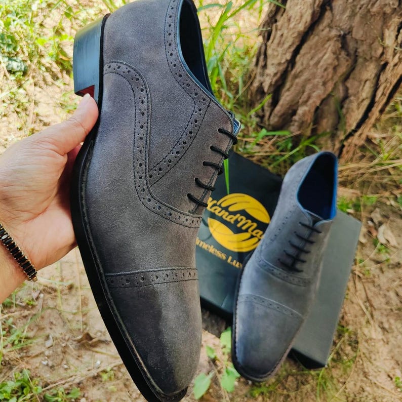 Handmade grey suede oxfords with leather sole and cushioned insole, crafted for men’s formal and business wear.